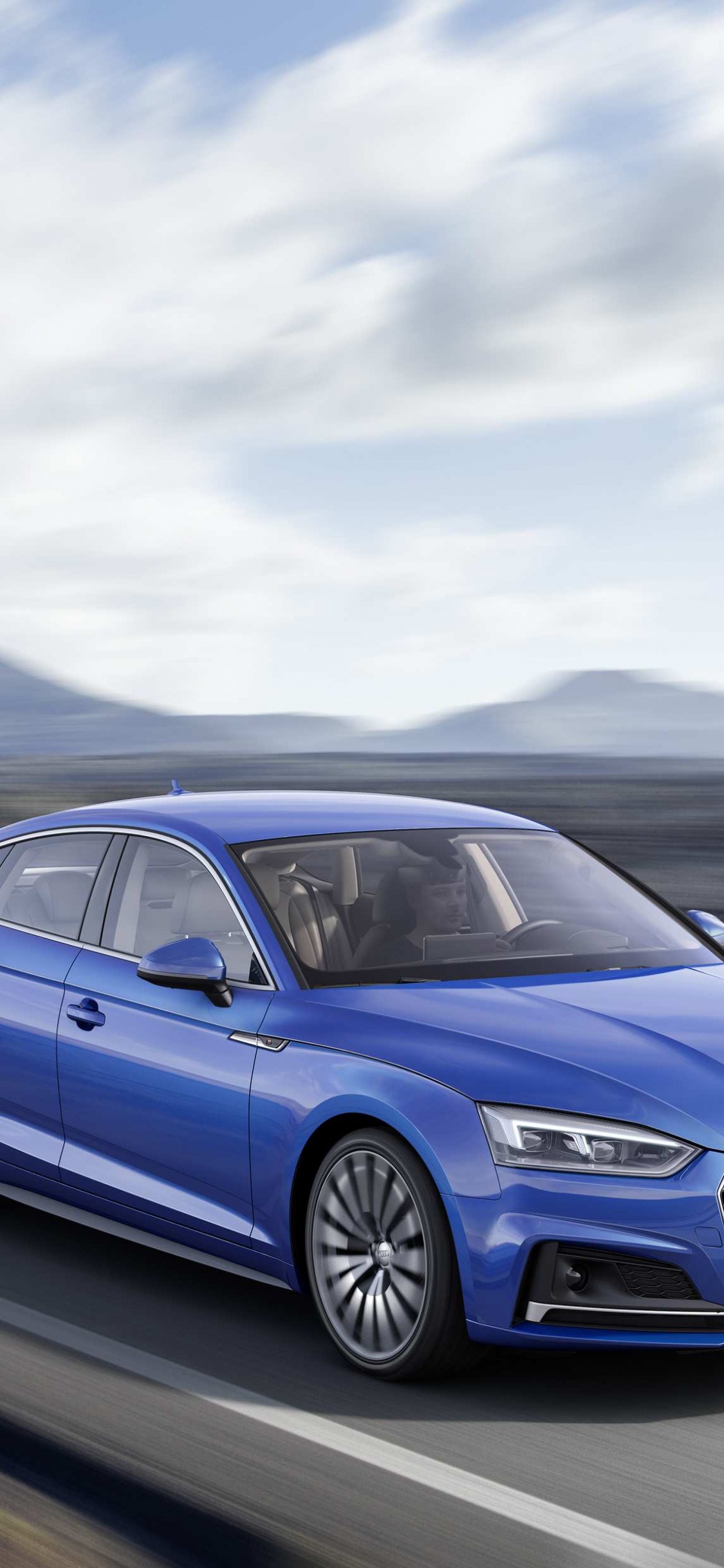 Blauer Audi a 4 Tagsüber Unterwegs. Wallpaper in 1125x2436 Resolution