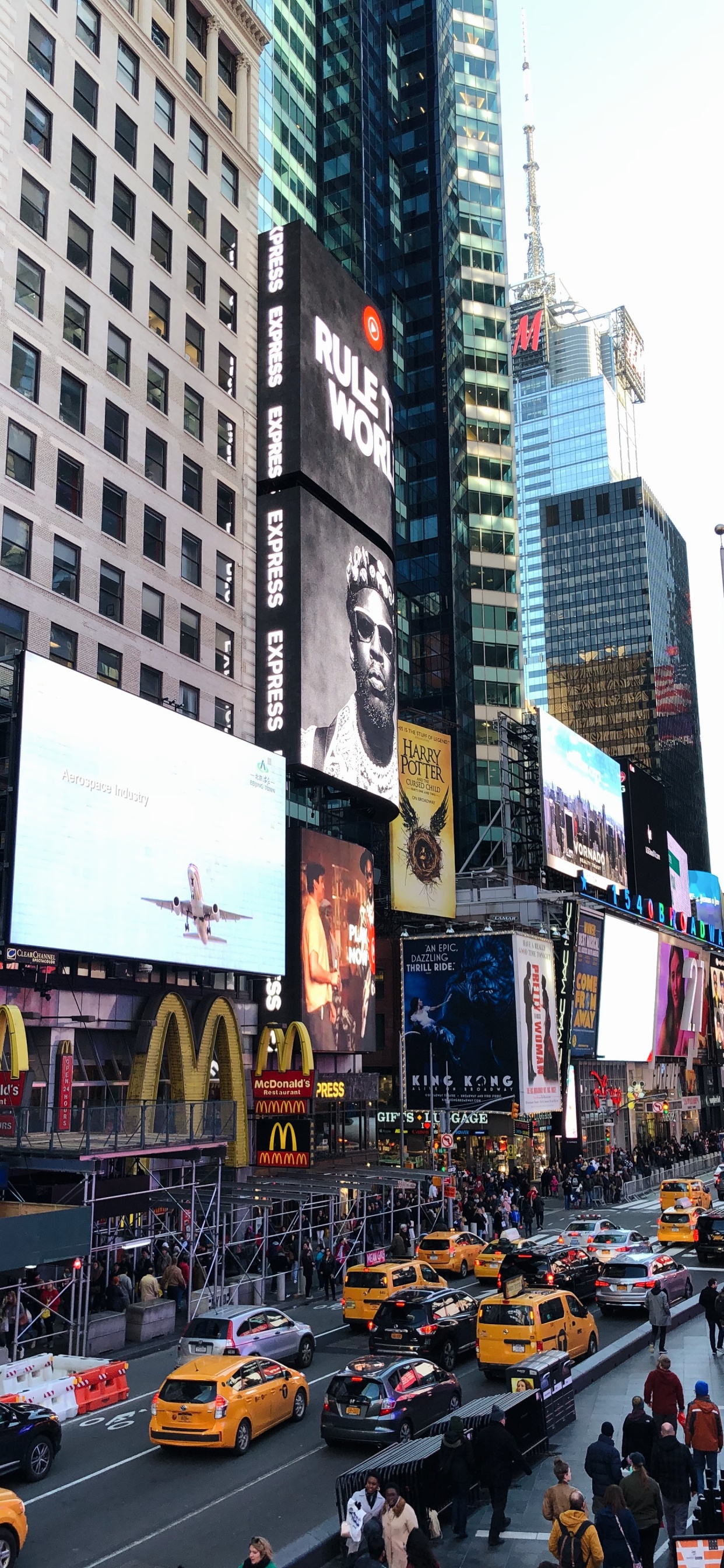 Cars on Road in Between High Rise Buildings During Daytime. Wallpaper in 1242x2688 Resolution
