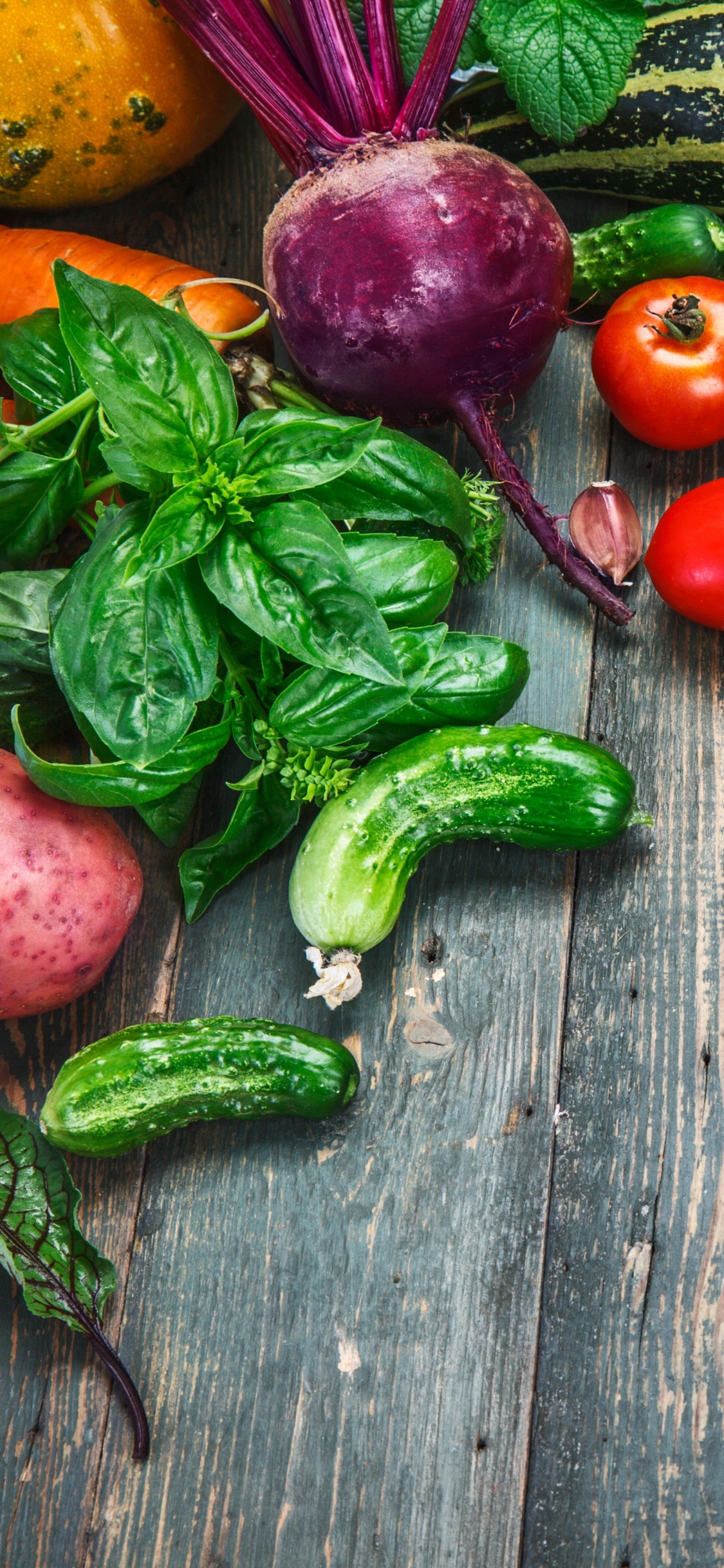 Red and Green Chili Peppers on Brown Wooden Table. Wallpaper in 1125x2436 Resolution