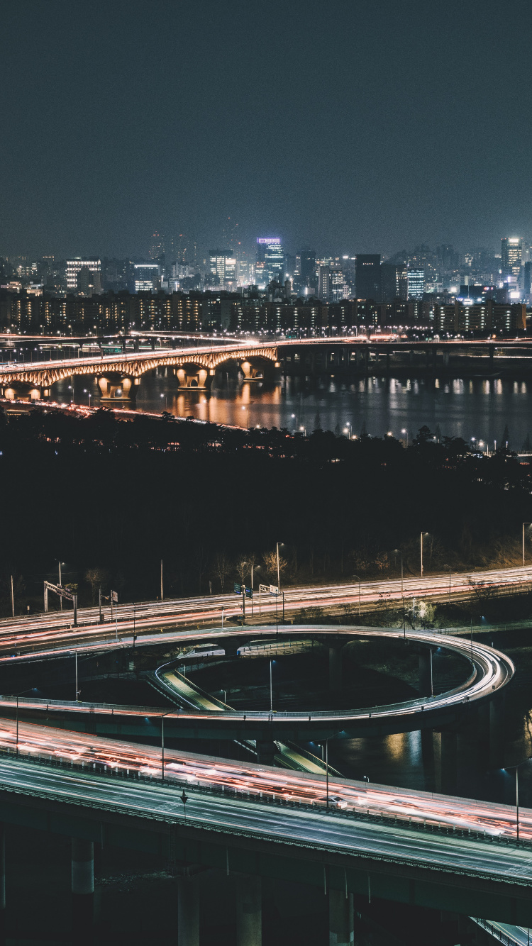 White and Black Bridge Over River During Night Time. Wallpaper in 750x1334 Resolution