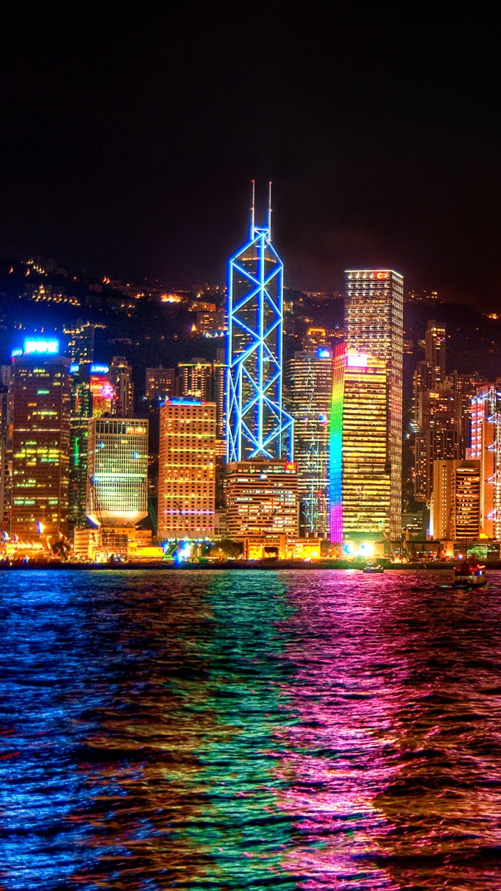 City Skyline Across Body of Water During Night Time. Wallpaper in 720x1280 Resolution