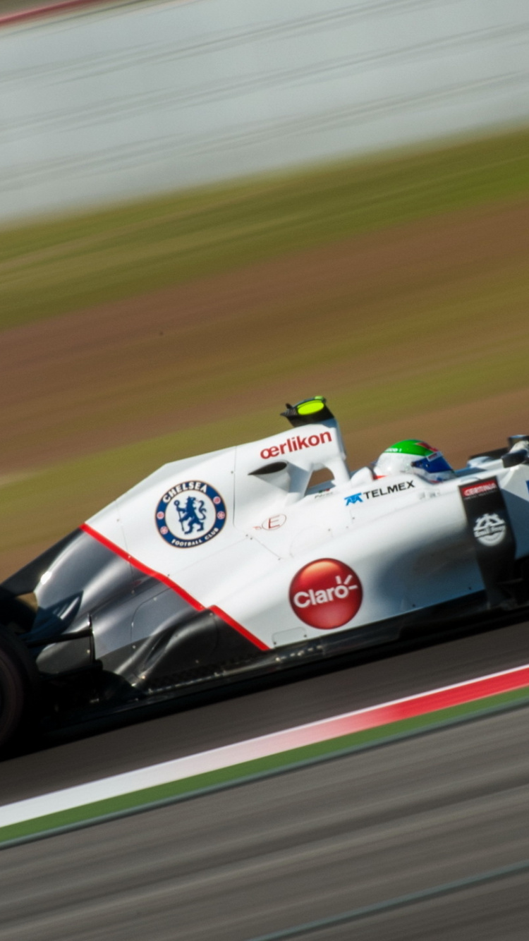 Weißes Und Rotes f 1 Auto Tagsüber Unterwegs. Wallpaper in 750x1334 Resolution