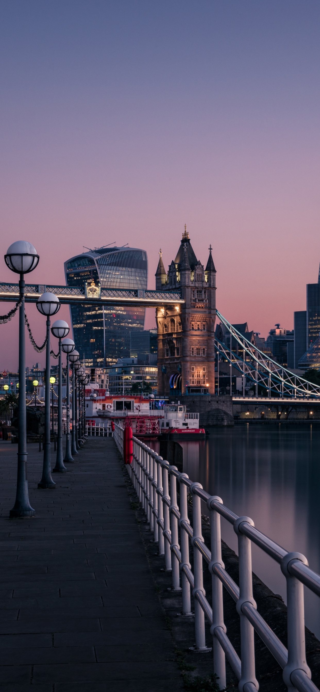 Bridge Over River Near City Buildings During Daytime. Wallpaper in 1242x2688 Resolution