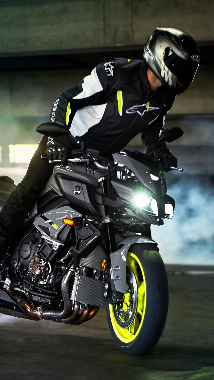 Man in Black Jacket Riding Motorcycle. Wallpaper in 750x1334 Resolution