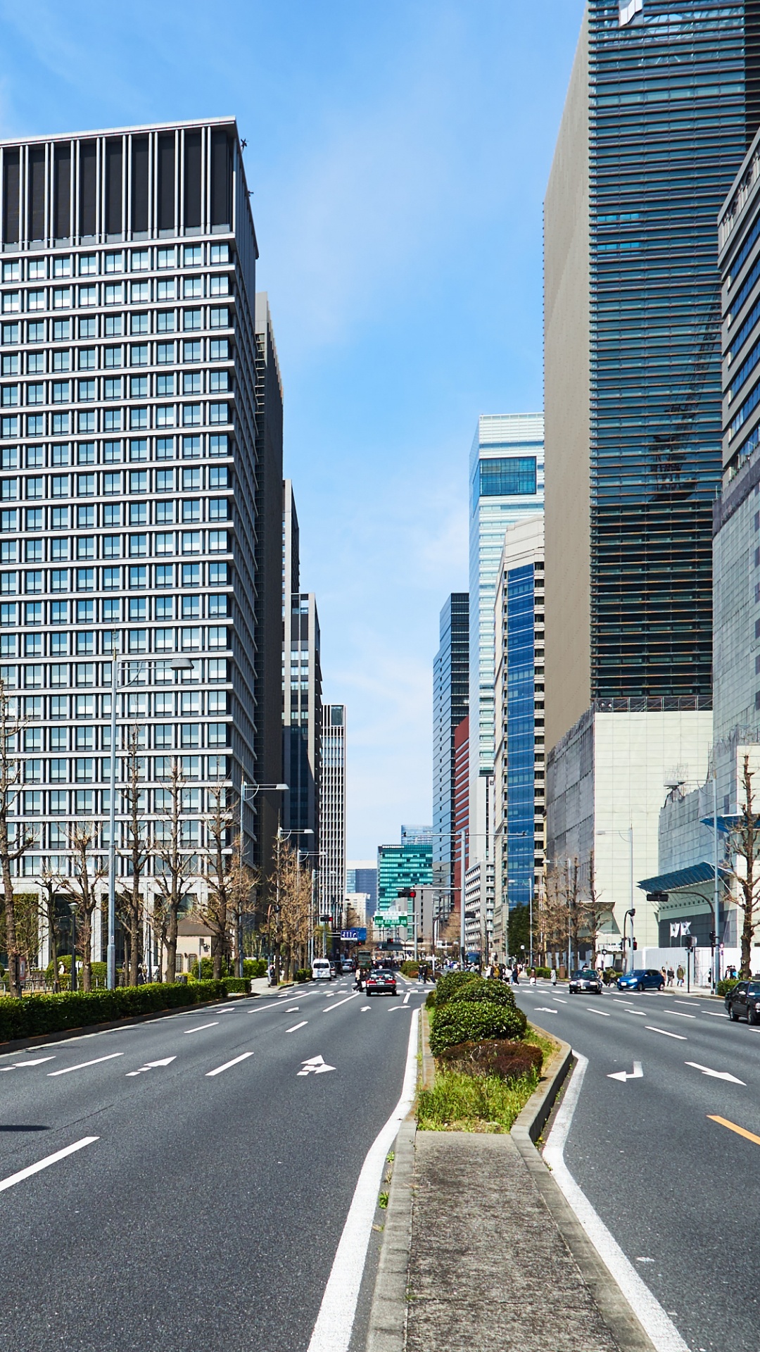 Gray Concrete Road Between High Rise Buildings During Daytime. Wallpaper in 1080x1920 Resolution