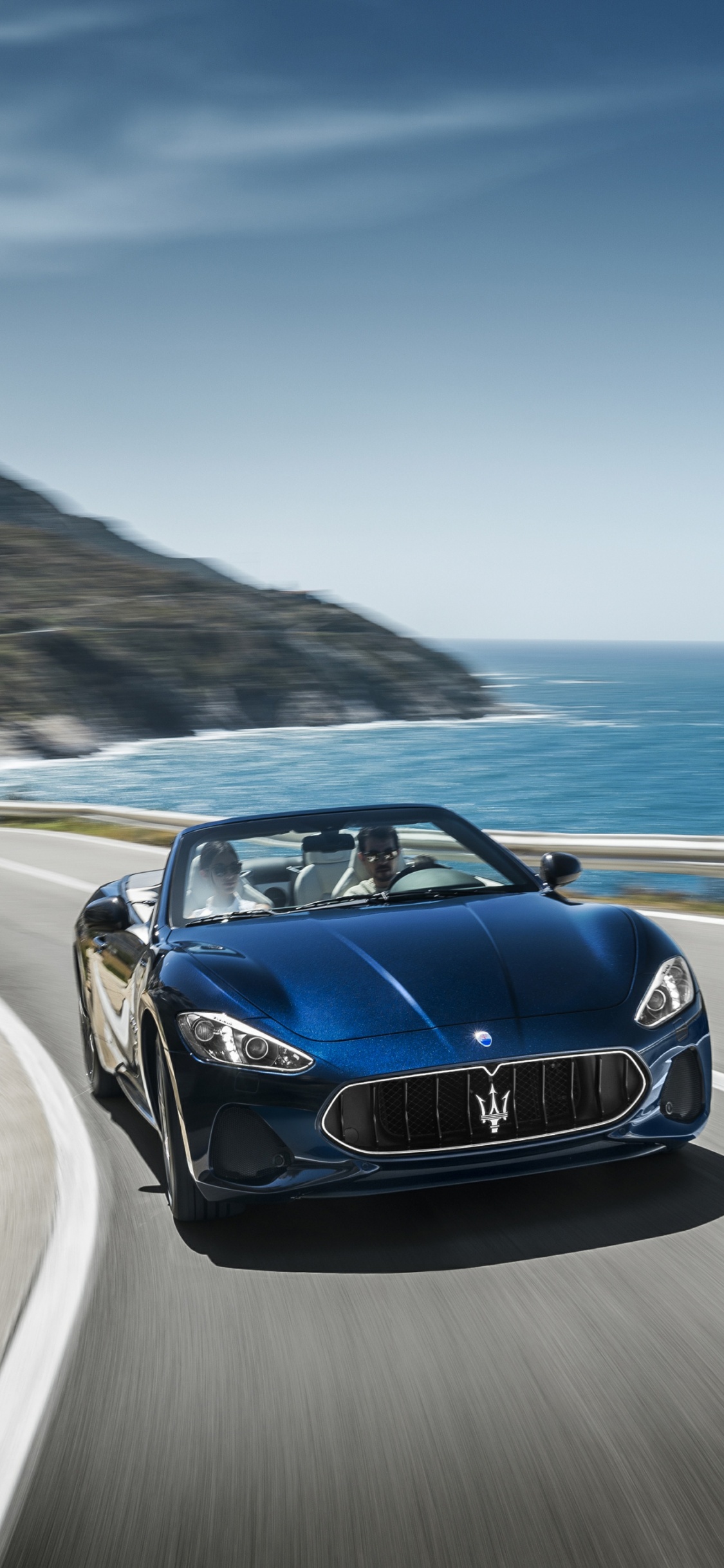 Blue Porsche 911 on Road Near Sea During Daytime. Wallpaper in 1125x2436 Resolution