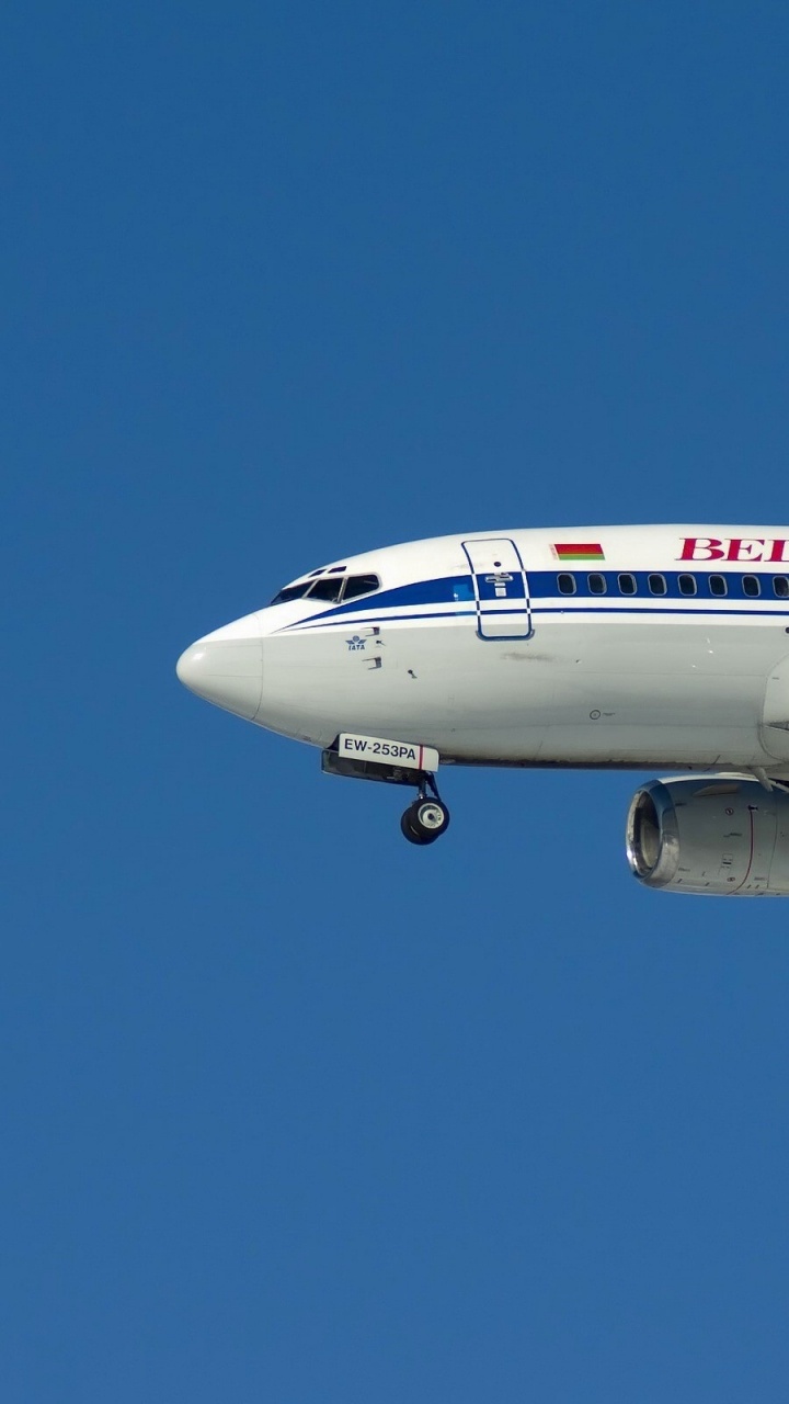 White and Red Passenger Plane in Flight. Wallpaper in 720x1280 Resolution