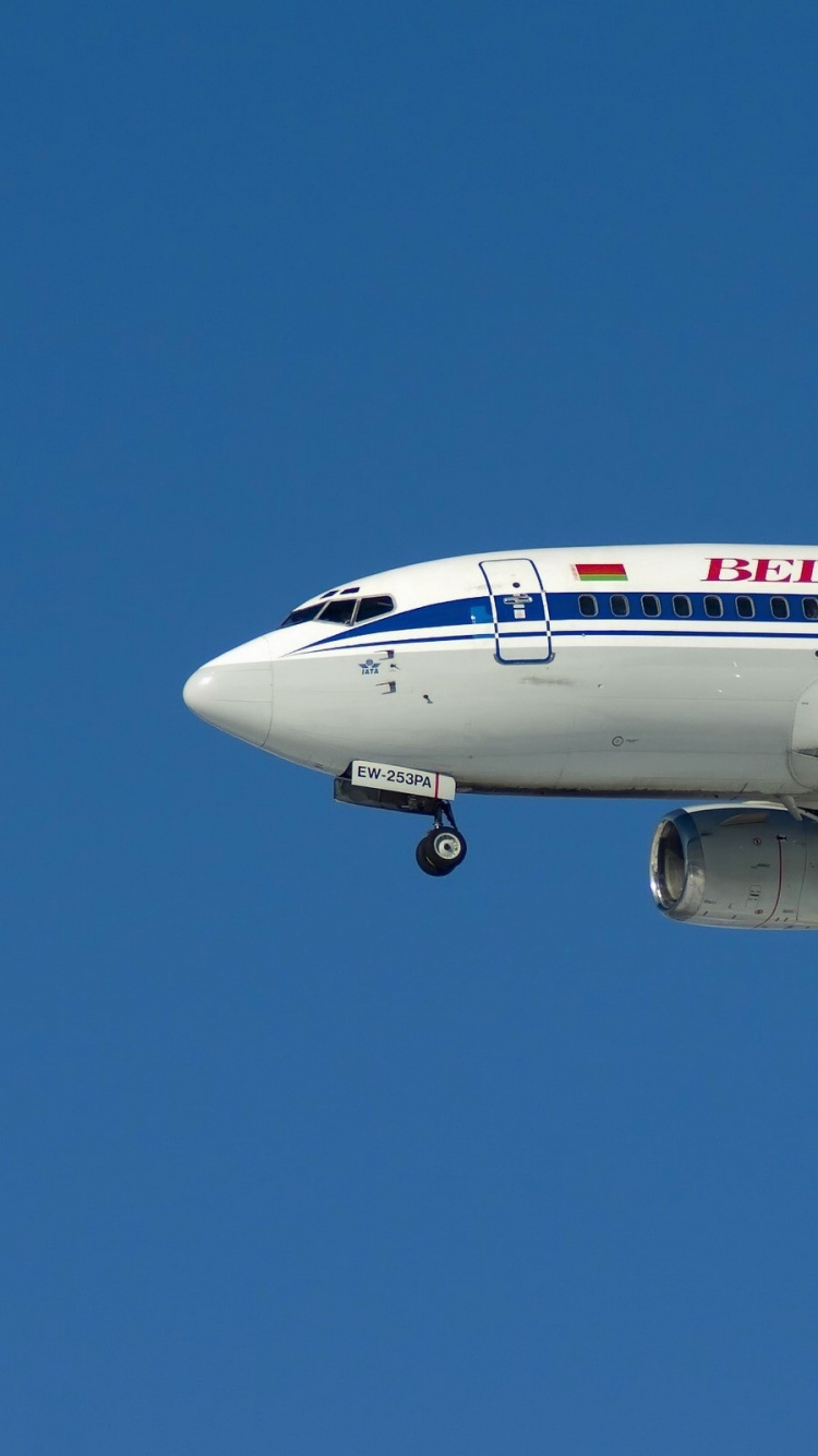 White and Red Passenger Plane in Flight. Wallpaper in 750x1334 Resolution