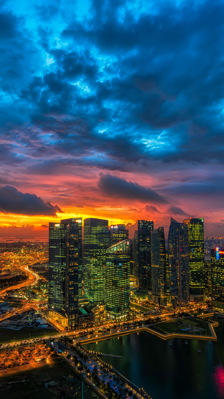 City Skyline Under Blue and Orange Cloudy Sky During Night Time. Wallpaper in 750x1334 Resolution