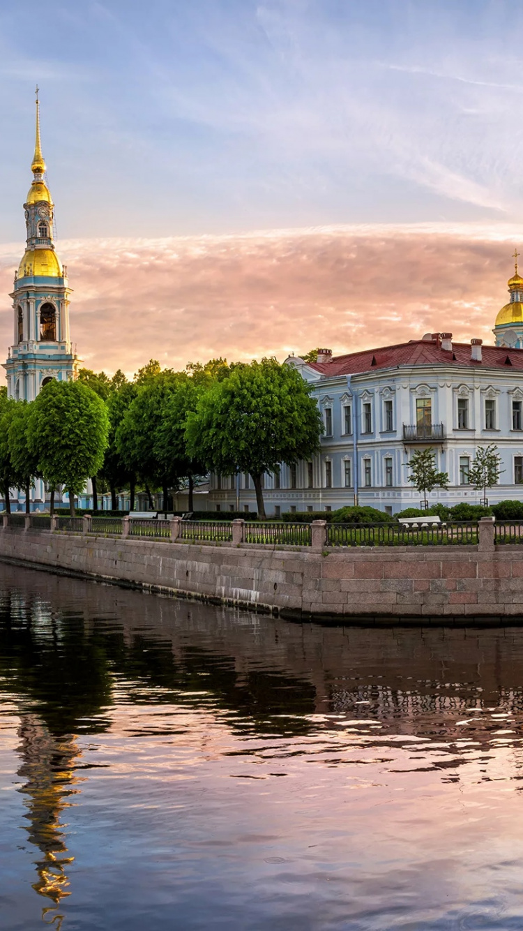 Bâtiment en Béton Blanc et Marron Près D'un Plan D'eau Pendant la Journée. Wallpaper in 750x1334 Resolution