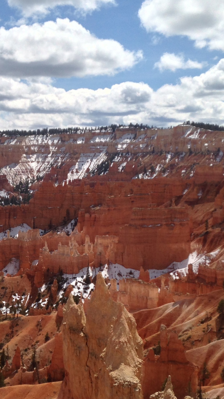 Brown Rocky Mountain Under Blue Sky and White Clouds During Daytime. Wallpaper in 750x1334 Resolution