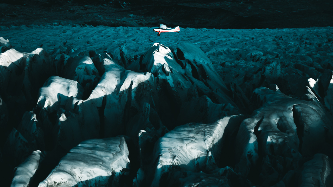 Person in Black Shirt Sitting on White Rock Formation. Wallpaper in 1280x720 Resolution
