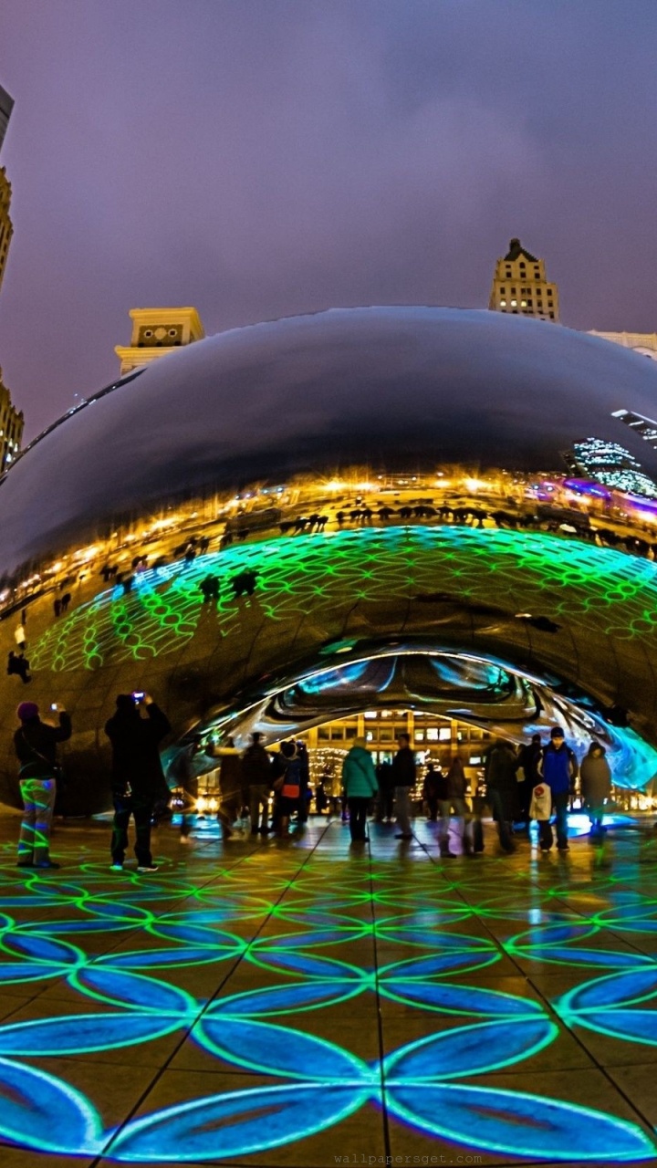 People Walking on Street Near High Rise Buildings During Night Time. Wallpaper in 720x1280 Resolution