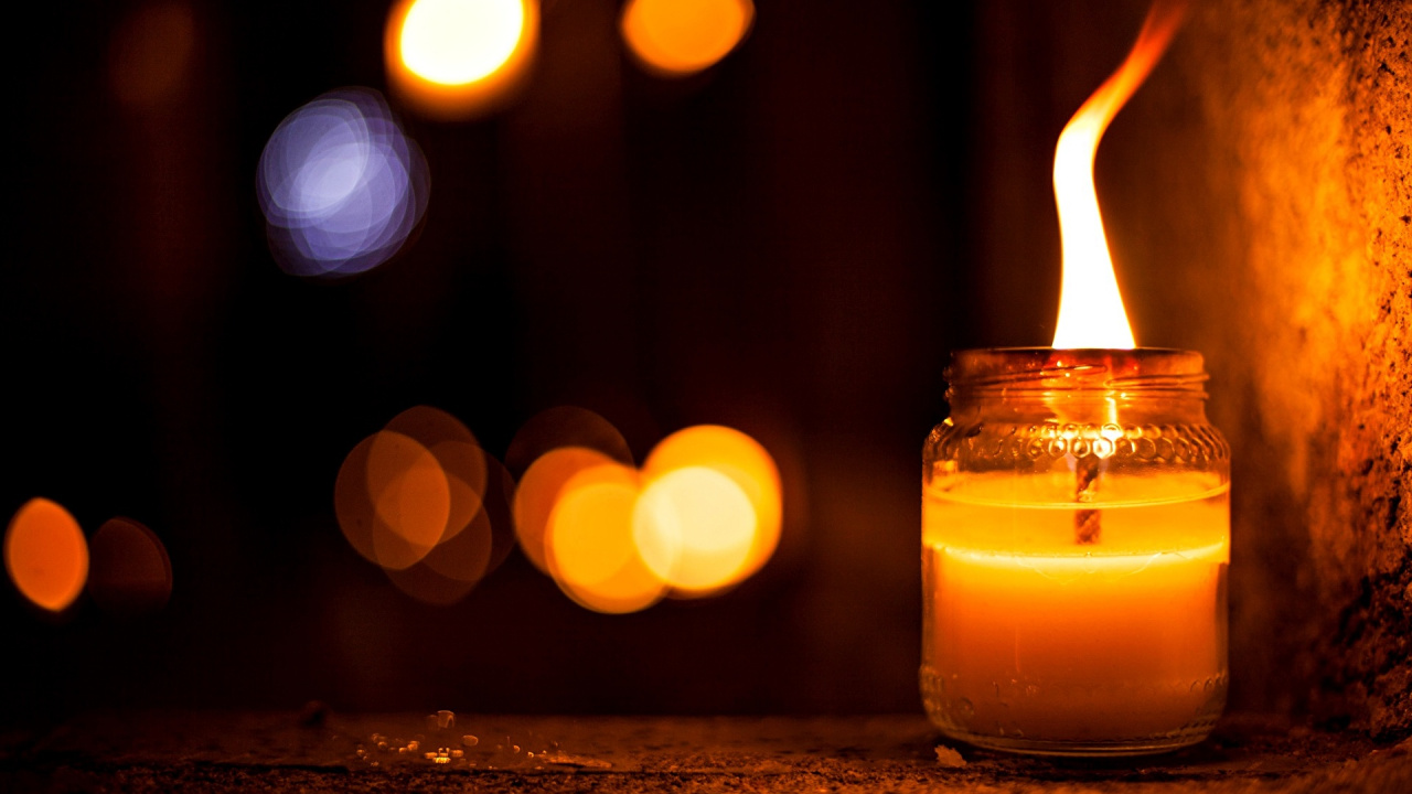 Lighted Candle in Clear Glass Container. Wallpaper in 1280x720 Resolution