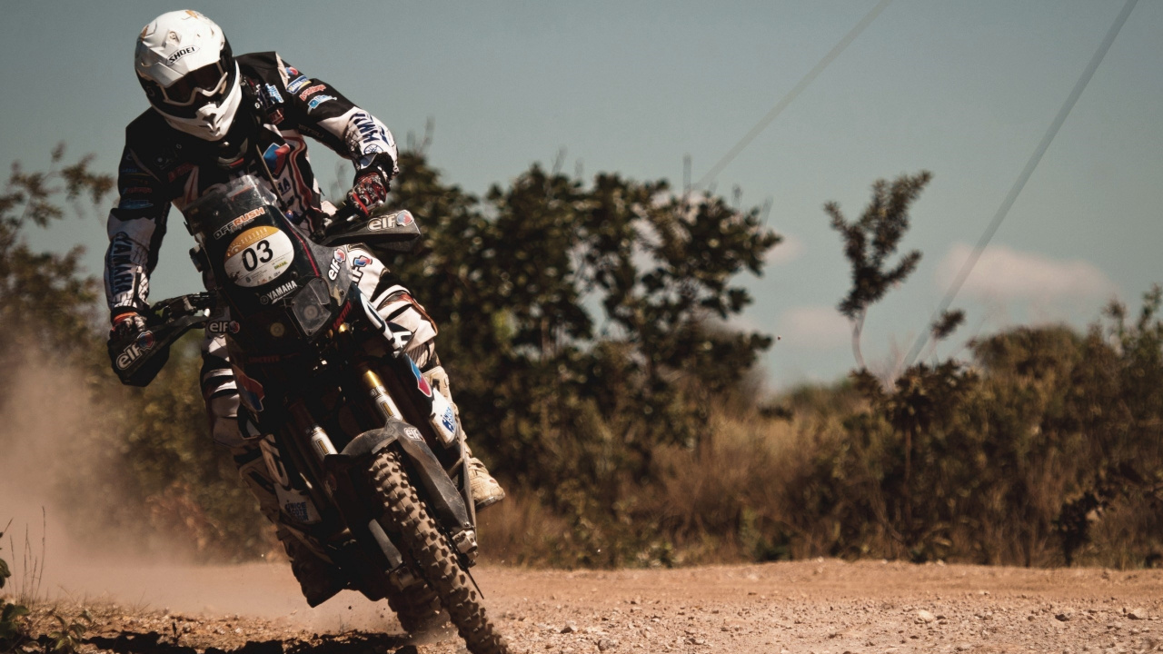 Man in Black and White Motorcycle Suit Riding Motocross Dirt Bike. Wallpaper in 1280x720 Resolution