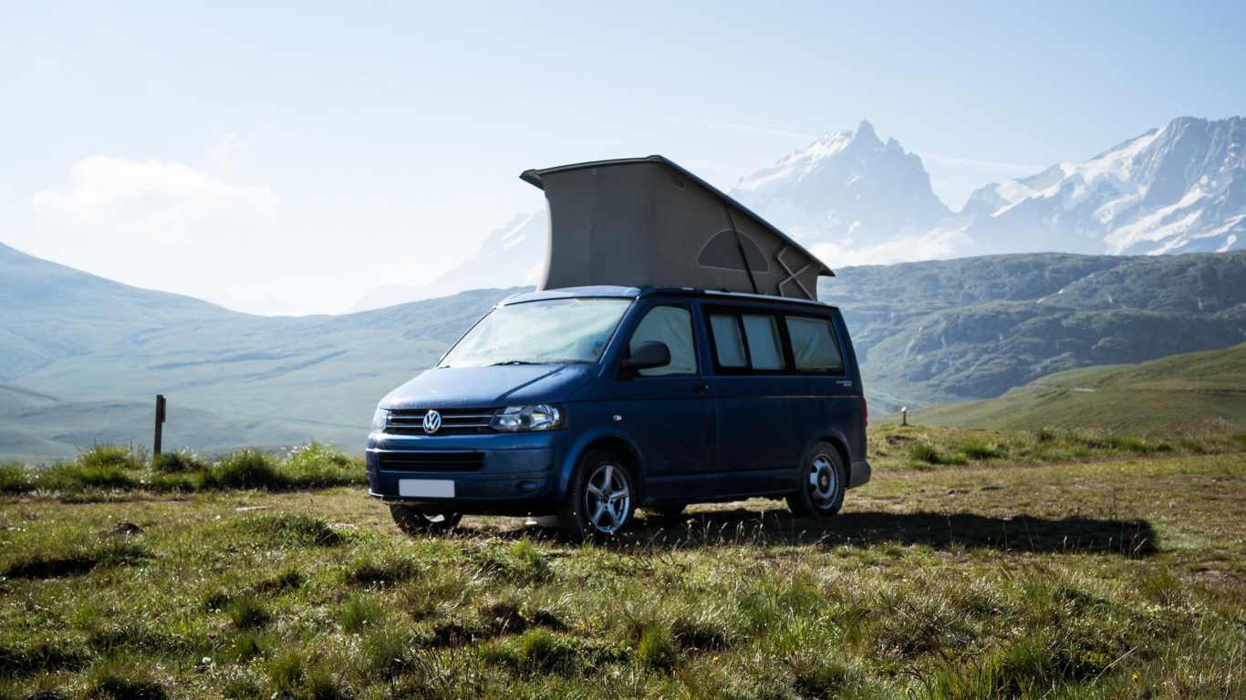Blue Suv on Green Grass Field Near Mountain During Daytime. Wallpaper in 1366x768 Resolution