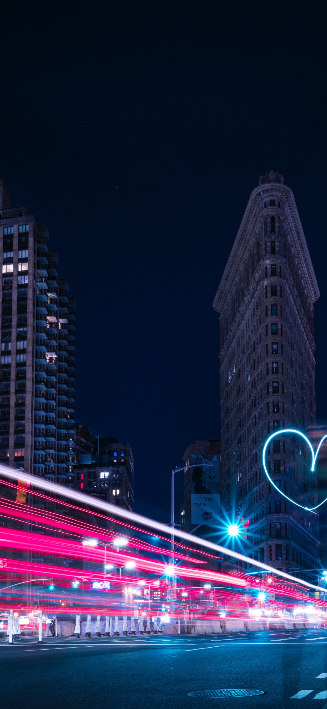 Time Lapse Photography of City Buildings During Night Time. Wallpaper in 1125x2436 Resolution