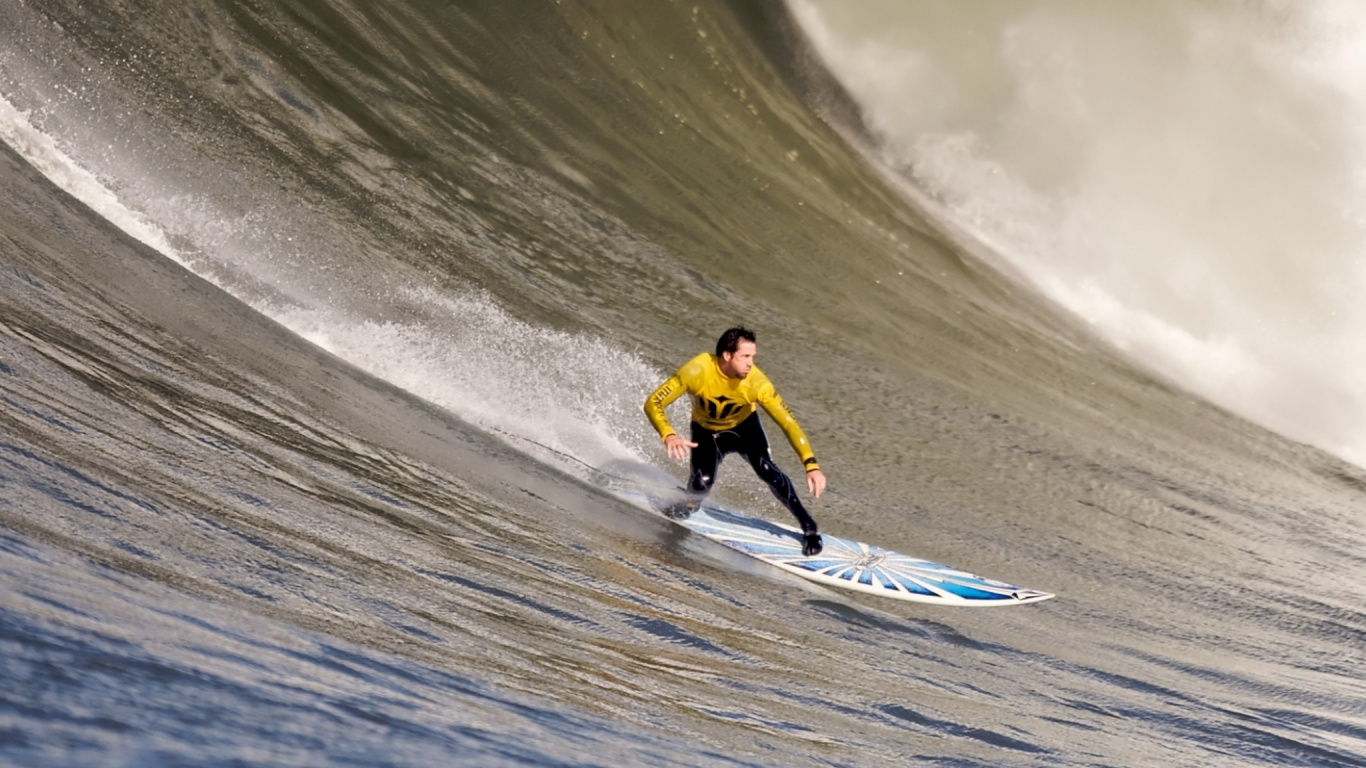 Mann in Gelbem Hemd Und Schwarzer Hose, Der Tagsüber Auf Einem Weißen Surfbrett am Strand Reitet. Wallpaper in 1366x768 Resolution