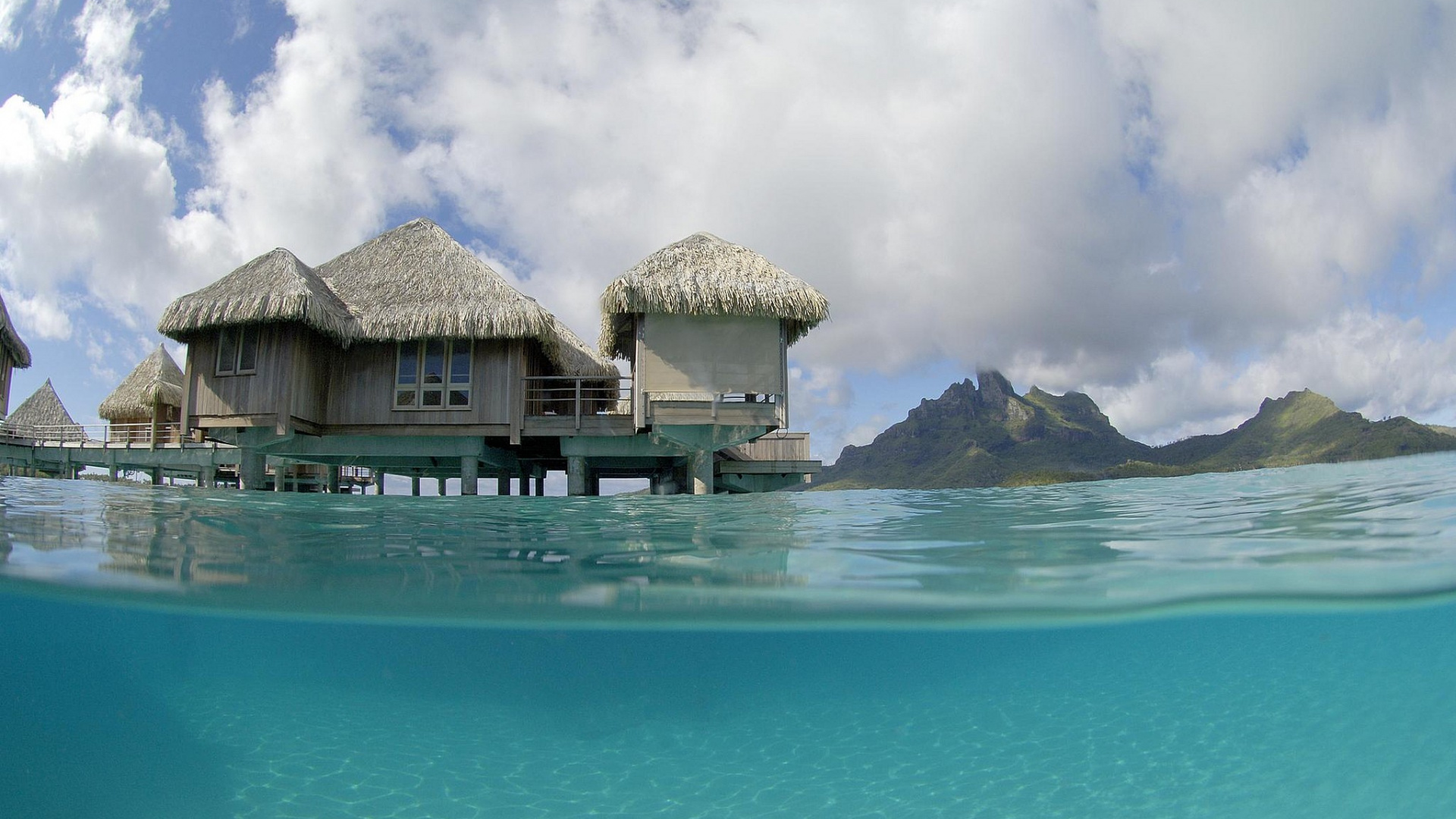 Brown Wooden House on Blue Sea Under Blue Sky During Daytime. Wallpaper in 1920x1080 Resolution