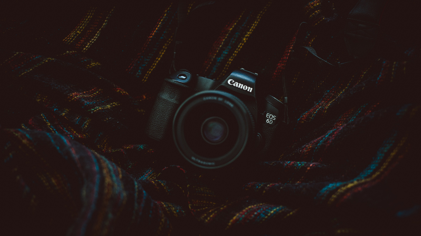 Black Nikon Dslr Camera on Black and Brown Textile. Wallpaper in 1366x768 Resolution