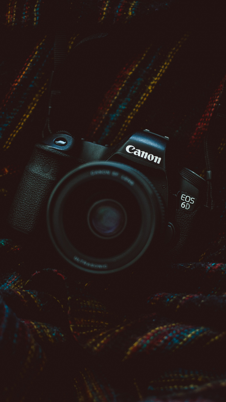Black Nikon Dslr Camera on Black and Brown Textile. Wallpaper in 750x1334 Resolution