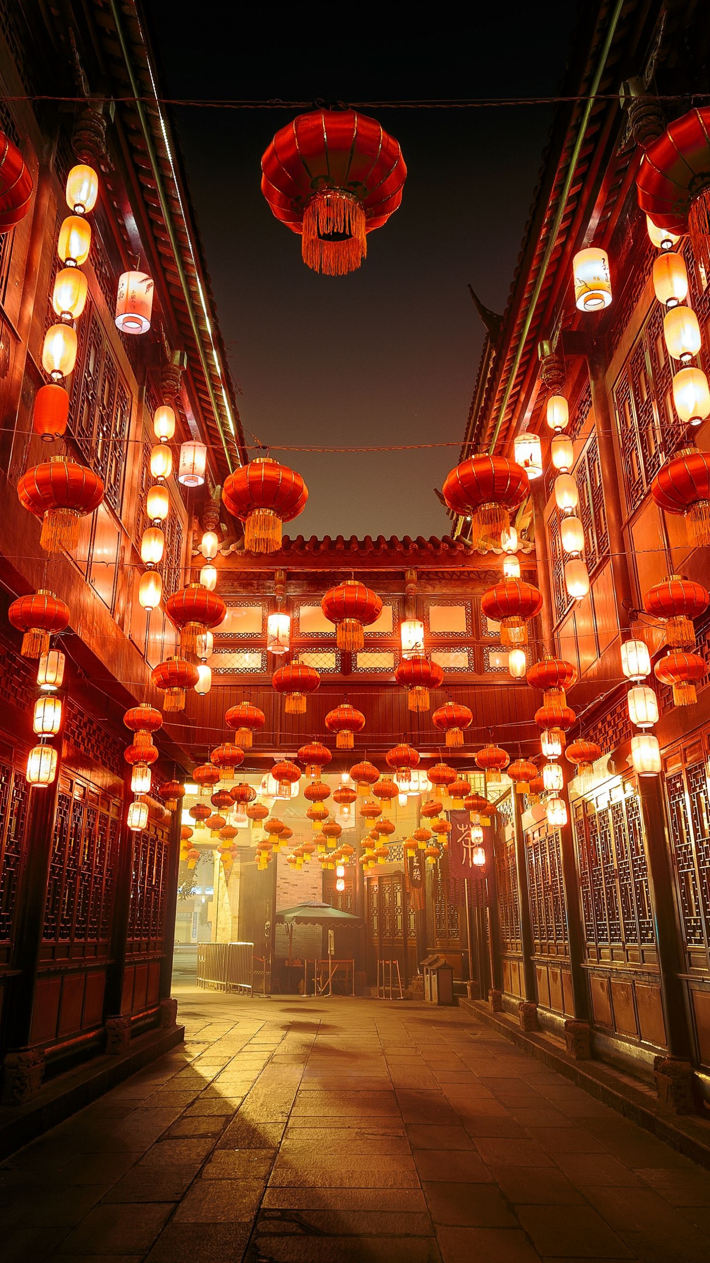 Red and White Pendant Lamps Turned on in Building. Wallpaper in 1440x2560 Resolution