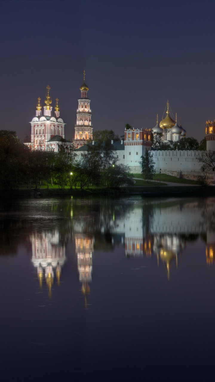 Body of Water Near City Buildings During Night Time. Wallpaper in 720x1280 Resolution