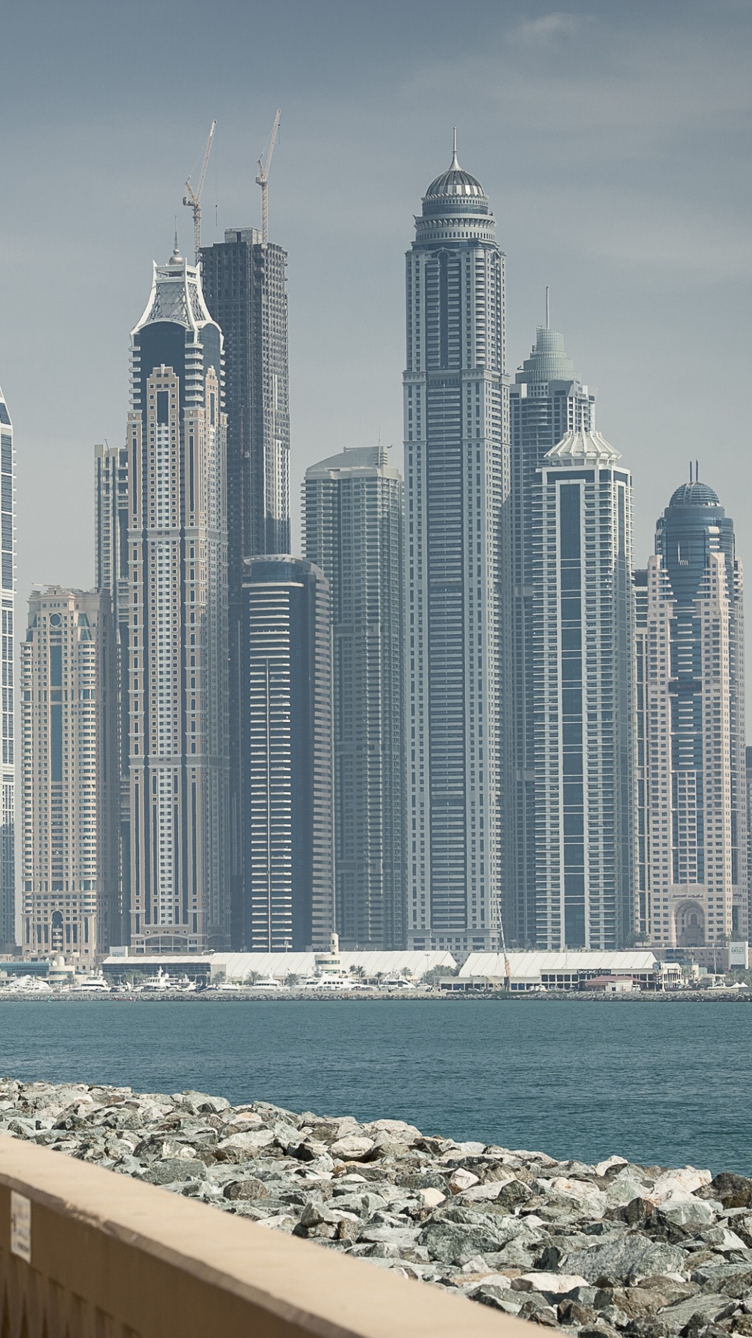 City Skyline Across The Sea During Daytime. Wallpaper in 1080x1920 Resolution