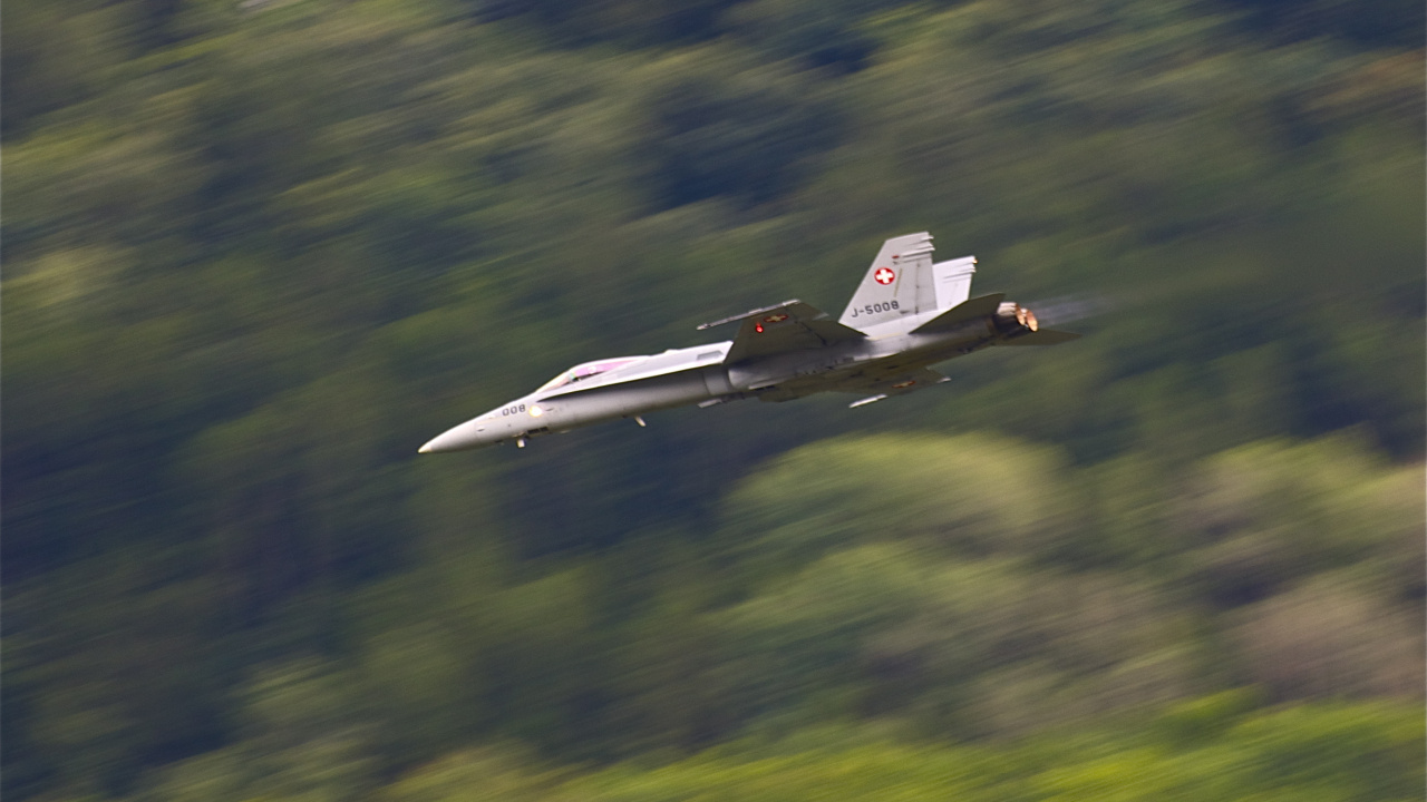 White Jet Plane Flying Over Green Grass Field During Daytime. Wallpaper in 1280x720 Resolution