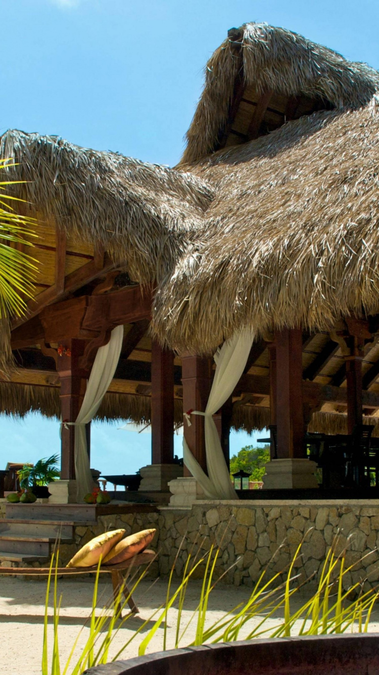 Brown Wooden Gazebo Near Palm Tree During Daytime. Wallpaper in 750x1334 Resolution