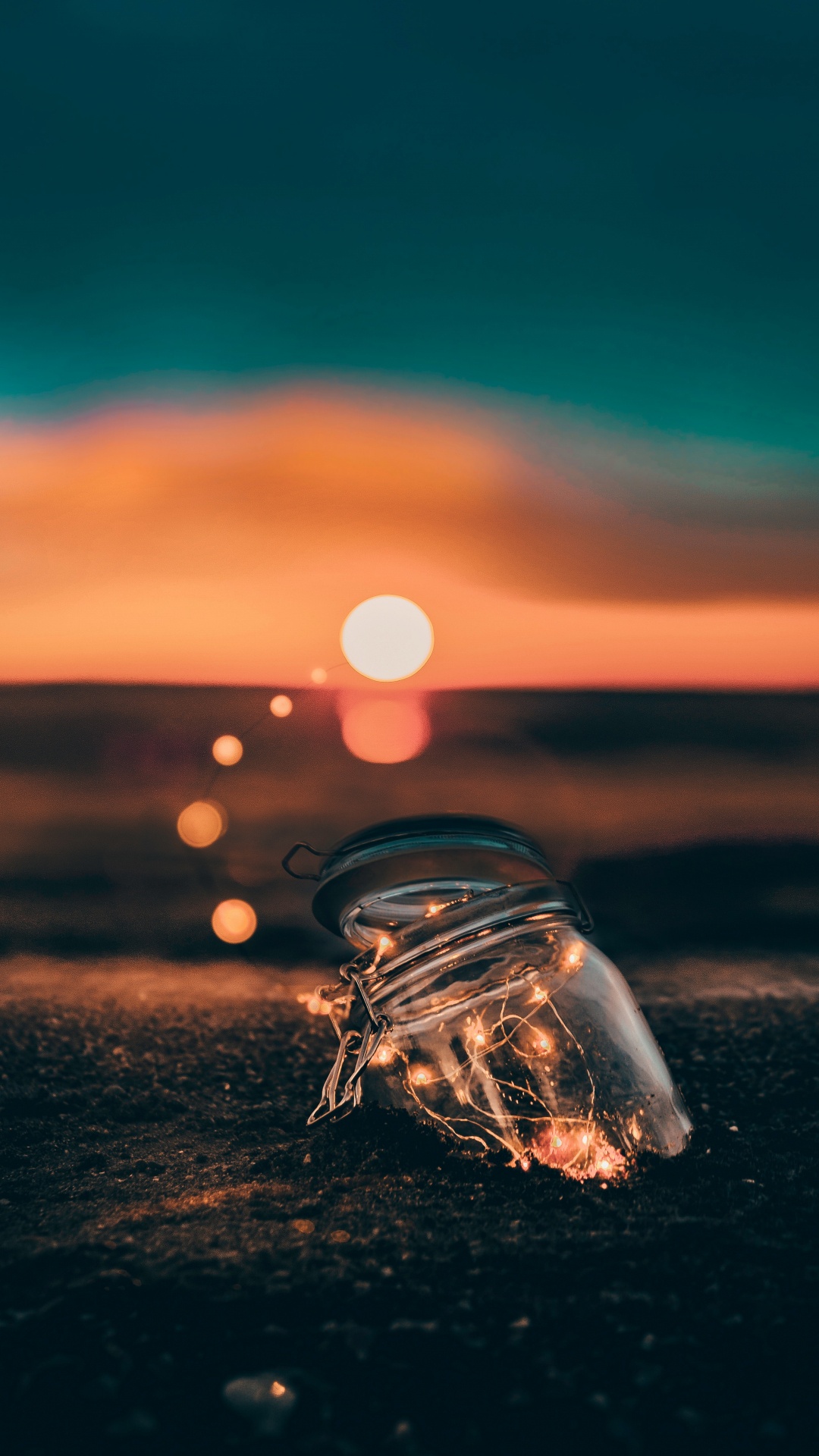 Clear Glass Bottle on Brown Sand During Sunset. Wallpaper in 1080x1920 Resolution