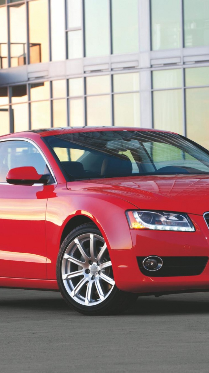 Red Audi a 4 Sedan Parked Near White Building During Daytime. Wallpaper in 720x1280 Resolution