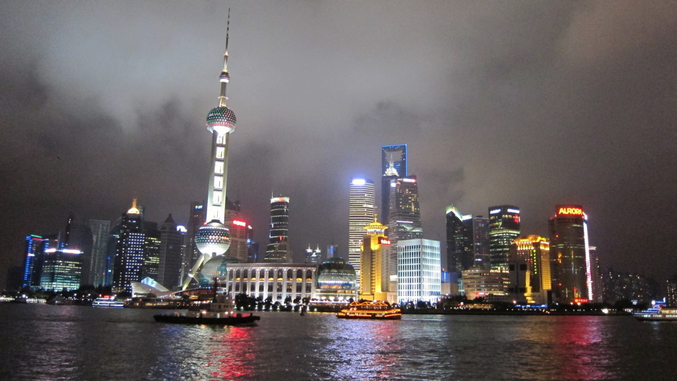 City Skyline Across Body of Water During Night Time. Wallpaper in 1366x768 Resolution