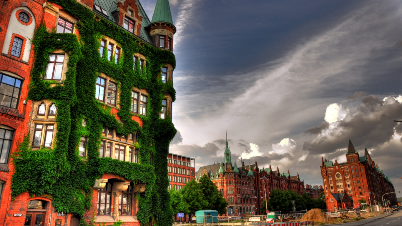 Green and Brown Concrete Building Under Gray Clouds. Wallpaper in 1366x768 Resolution