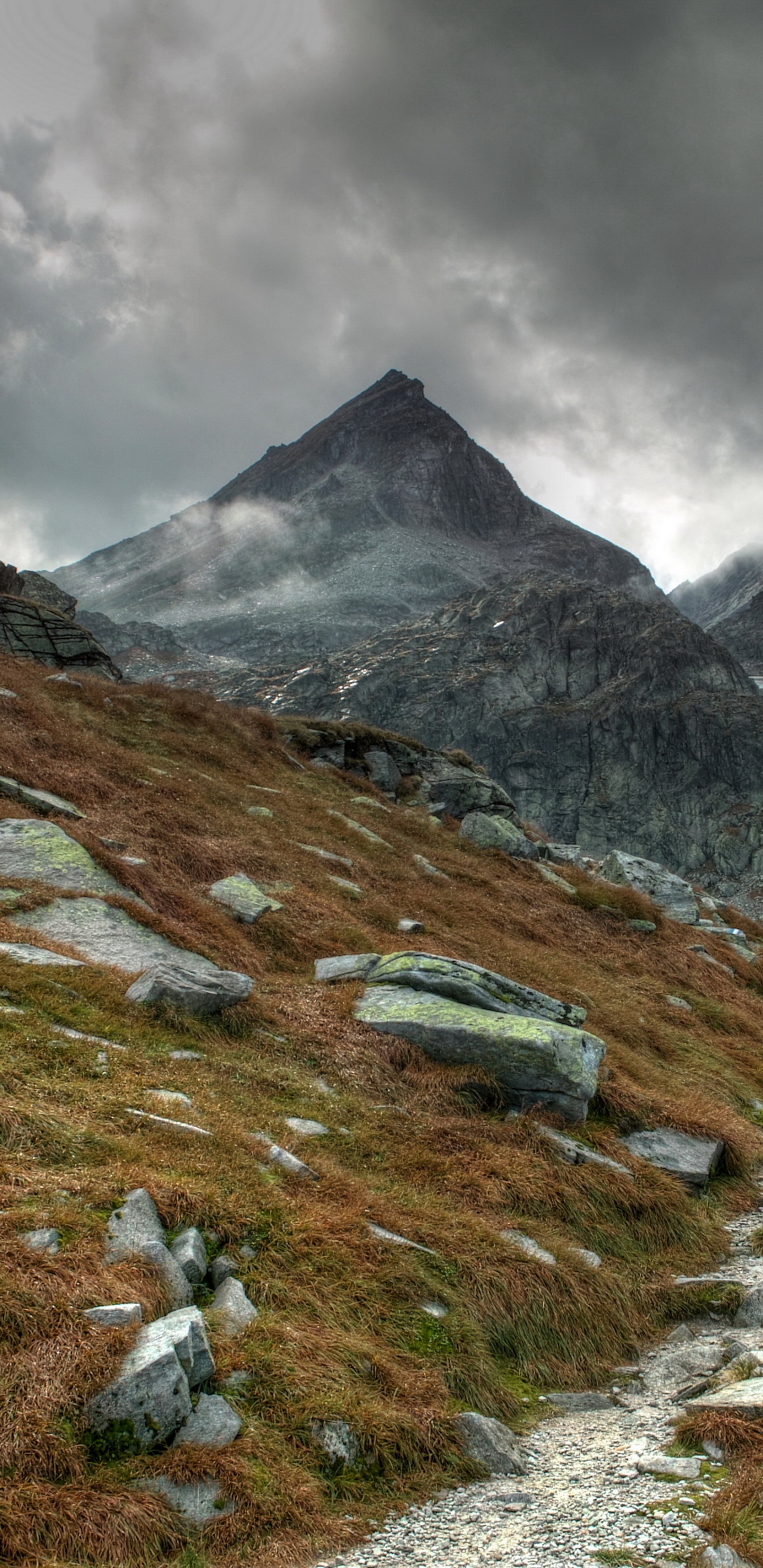 Green Grass Field Near Mountain Under Cloudy Sky During Daytime. Wallpaper in 1440x2960 Resolution