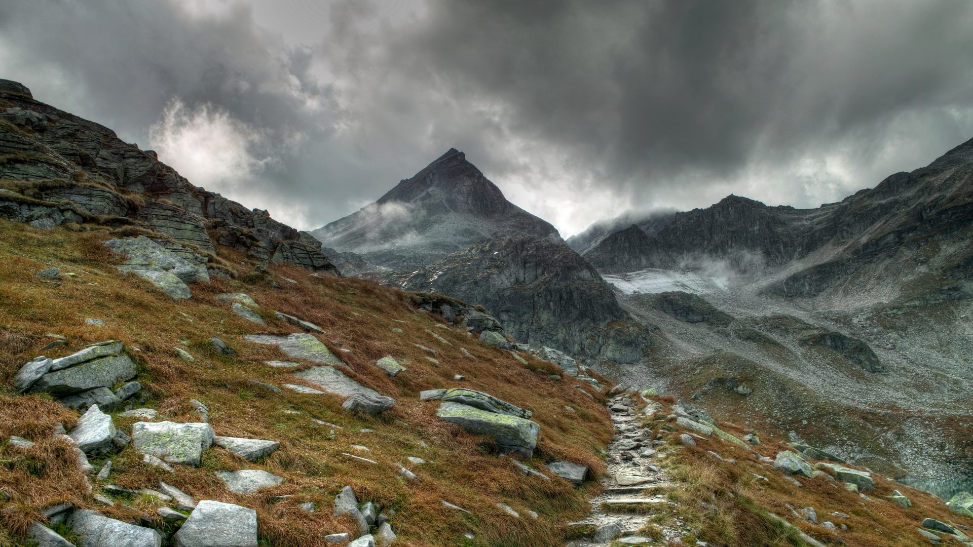 Green Grass Field Near Mountain Under Cloudy Sky During Daytime. Wallpaper in 1920x1080 Resolution