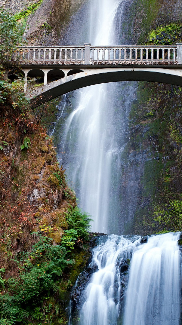 Waterfalls Under Bridge During Daytime. Wallpaper in 750x1334 Resolution