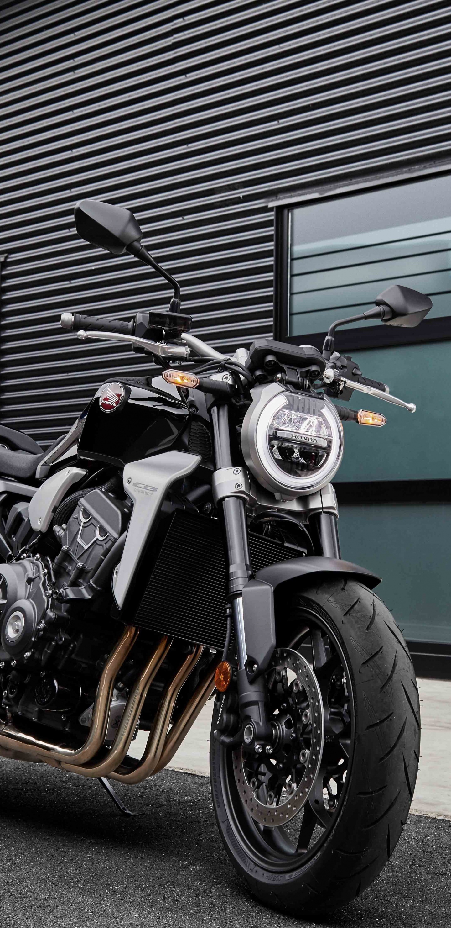 Man in Black Jacket Standing Beside Black and Silver Cruiser Motorcycle. Wallpaper in 1440x2960 Resolution