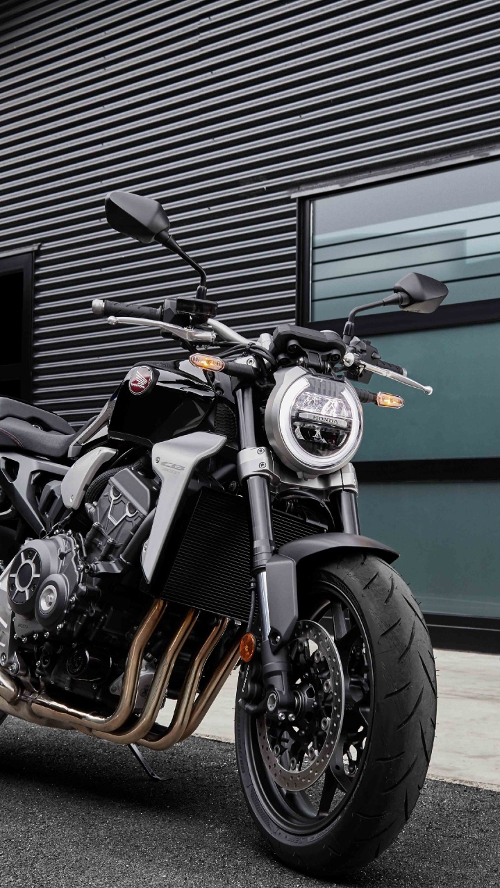 Man in Black Jacket Standing Beside Black and Silver Cruiser Motorcycle. Wallpaper in 720x1280 Resolution