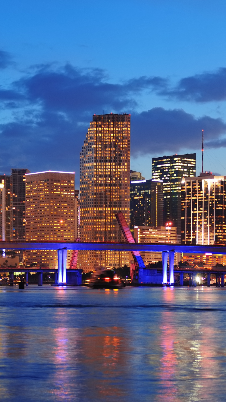 City Skyline Across Body of Water During Night Time. Wallpaper in 750x1334 Resolution