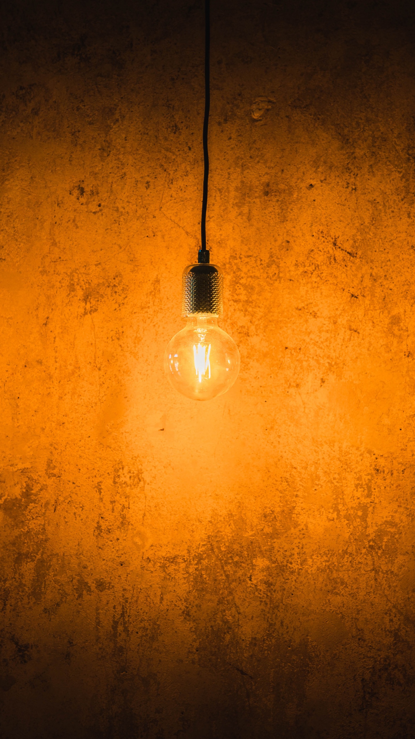 White Light Bulb Turned on on Orange Wall. Wallpaper in 1440x2560 Resolution