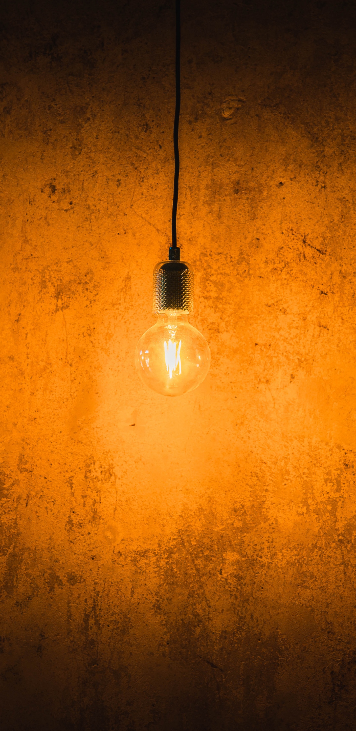 White Light Bulb Turned on on Orange Wall. Wallpaper in 1440x2960 Resolution