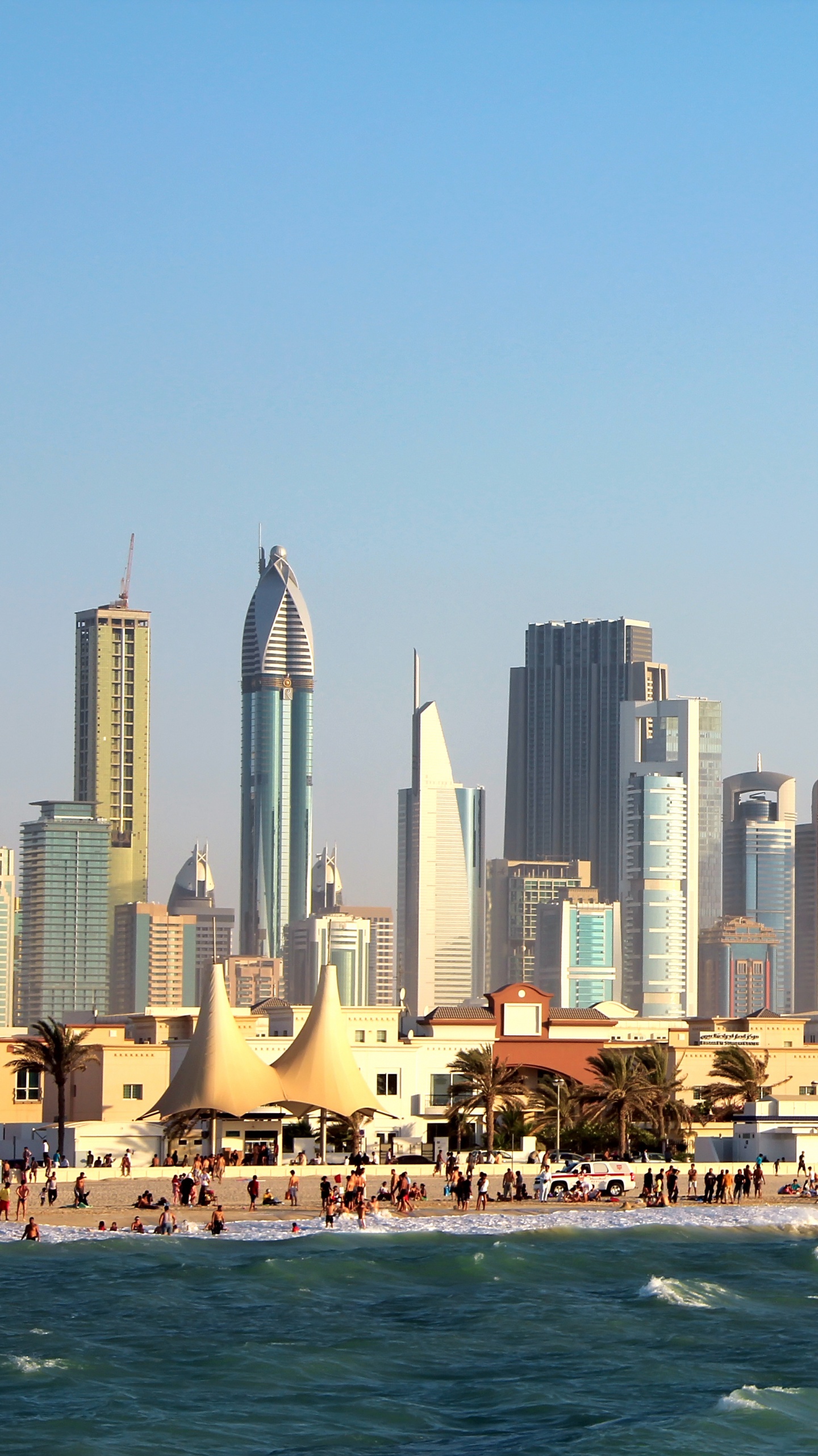 City Skyline Across Body of Water During Daytime. Wallpaper in 1440x2560 Resolution