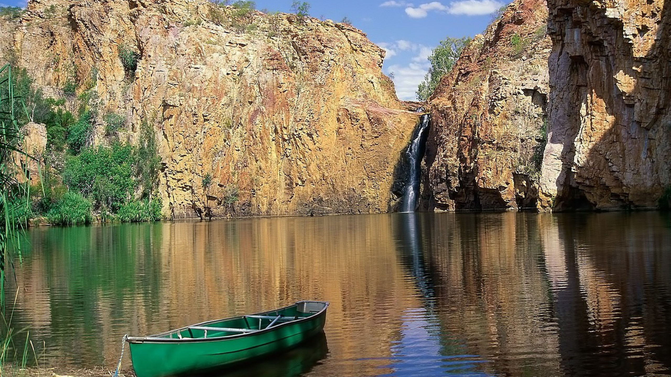 Green Boat on Lake Near Brown Rocky Mountain During Daytime. Wallpaper in 2560x1440 Resolution