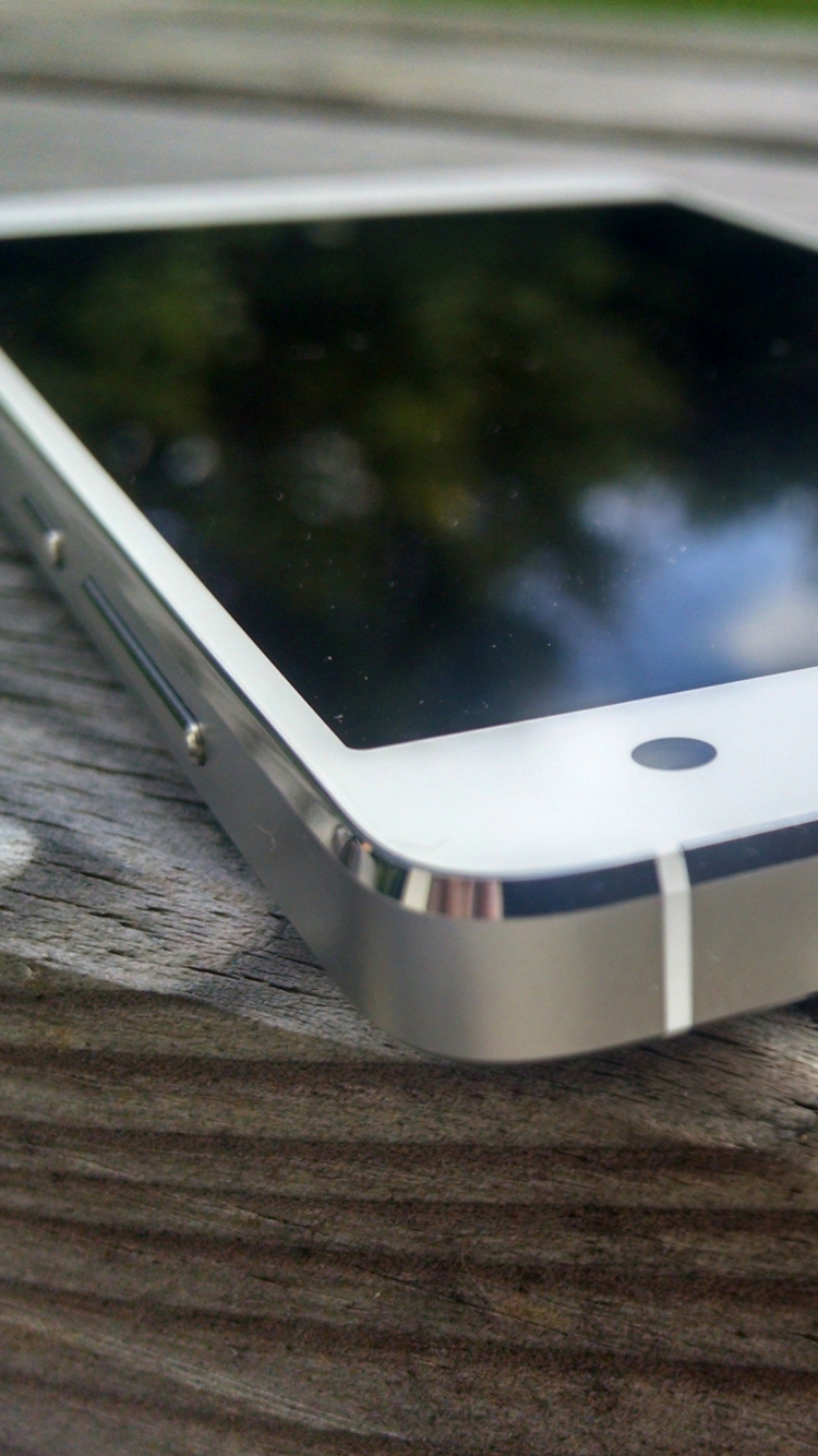 White Android Smartphone on Brown Textile. Wallpaper in 750x1334 Resolution