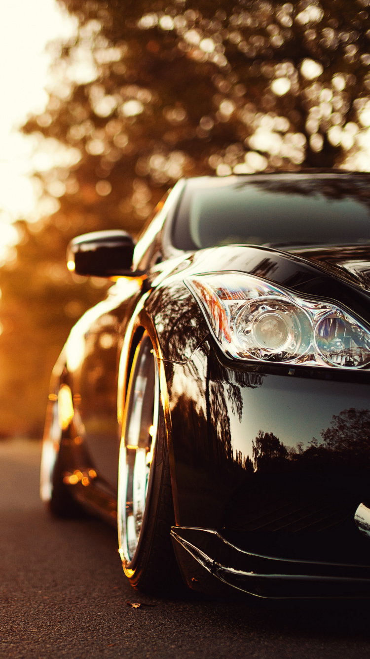 Porsche 911 Noire Sur Route Pendant le Coucher du Soleil. Wallpaper in 750x1334 Resolution