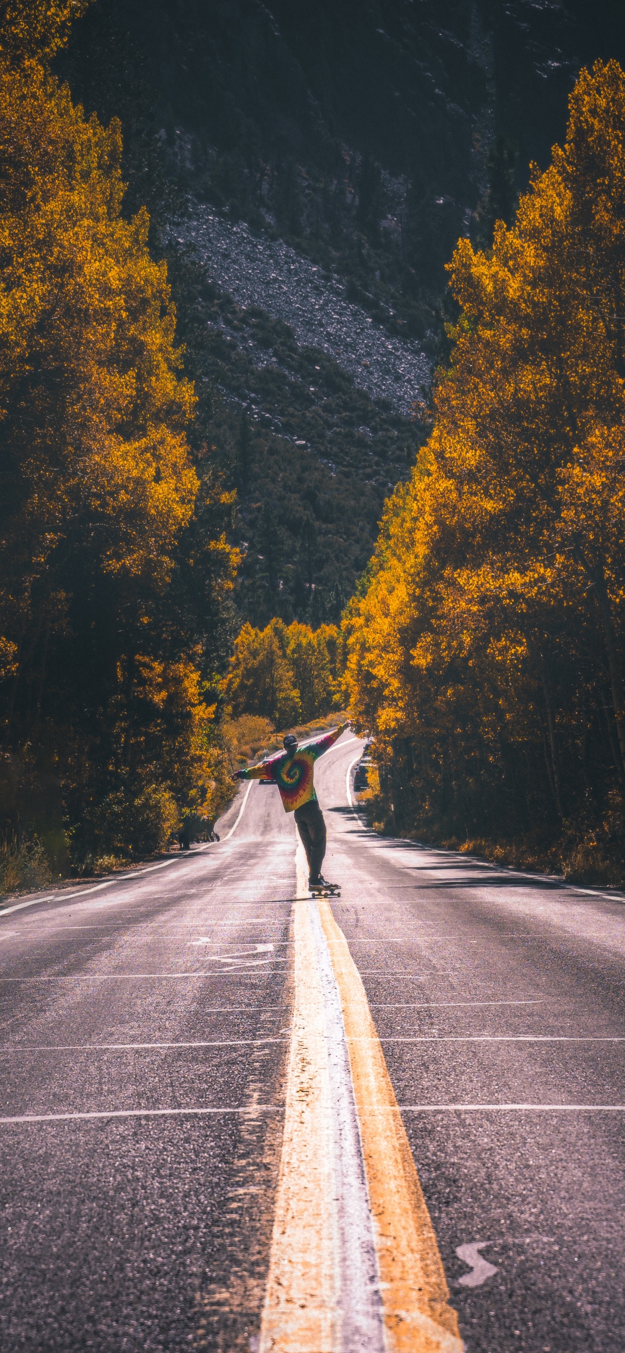 Man in Black Jacket Riding Bicycle on Gray Asphalt Road During Daytime. Wallpaper in 1242x2688 Resolution