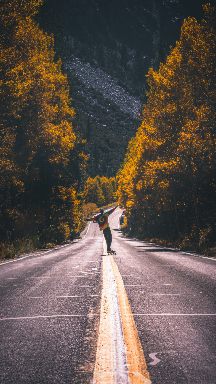 Man in Black Jacket Riding Bicycle on Gray Asphalt Road During Daytime. Wallpaper in 750x1334 Resolution