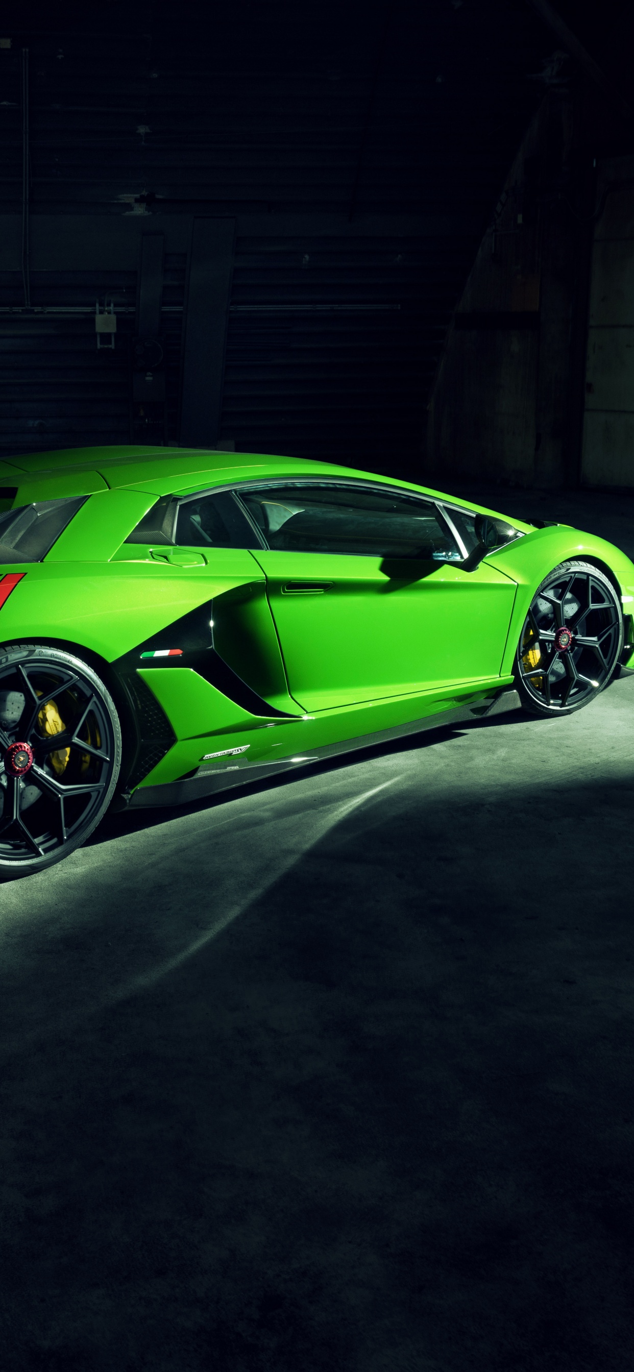 Green Porsche 911 Parked in Garage. Wallpaper in 1242x2688 Resolution
