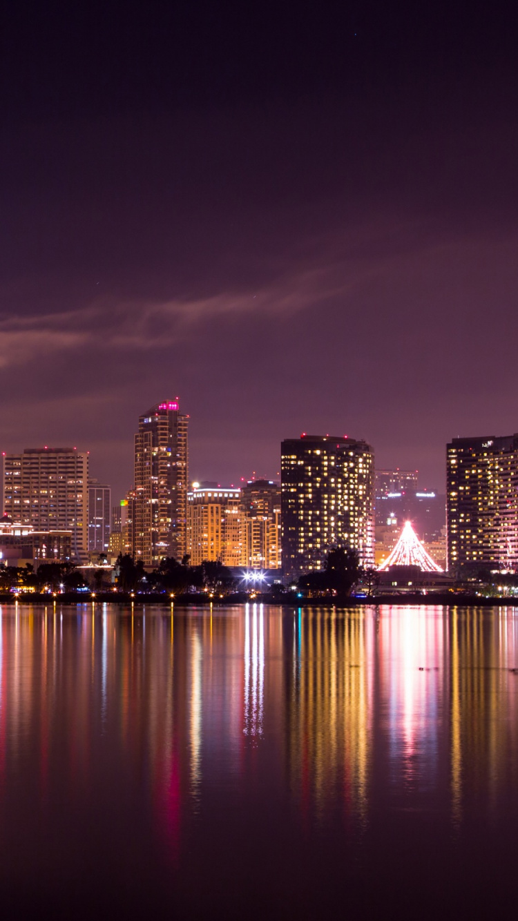 City Skyline Across Body of Water During Night Time. Wallpaper in 750x1334 Resolution
